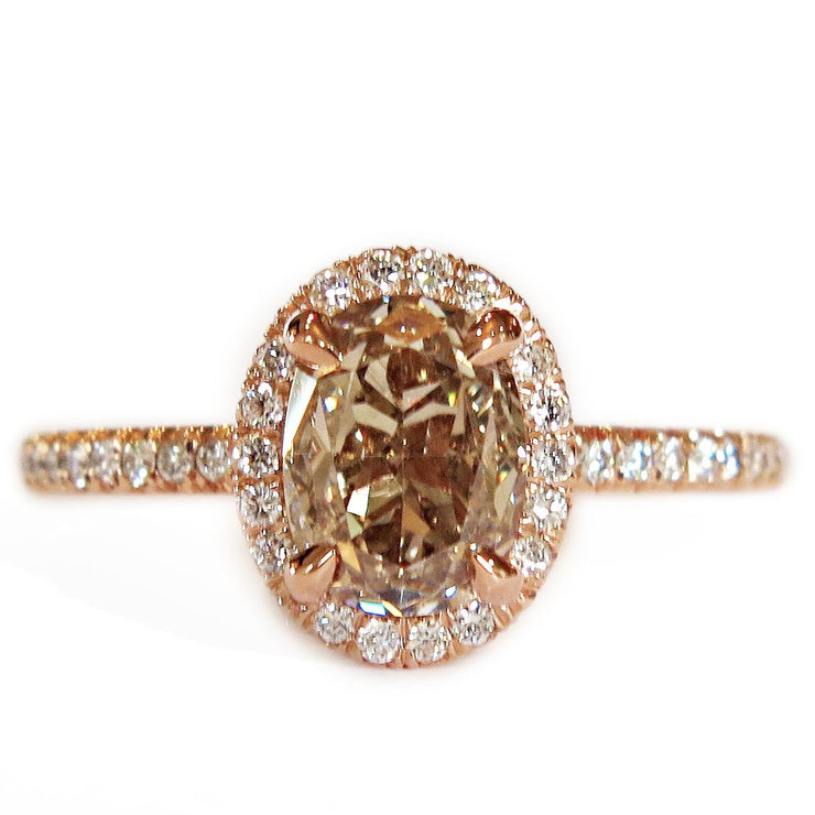 Unique champagne diamond engagement ring with white diamond halo, set in rose gold. By Dana Walden Bridal NYC.