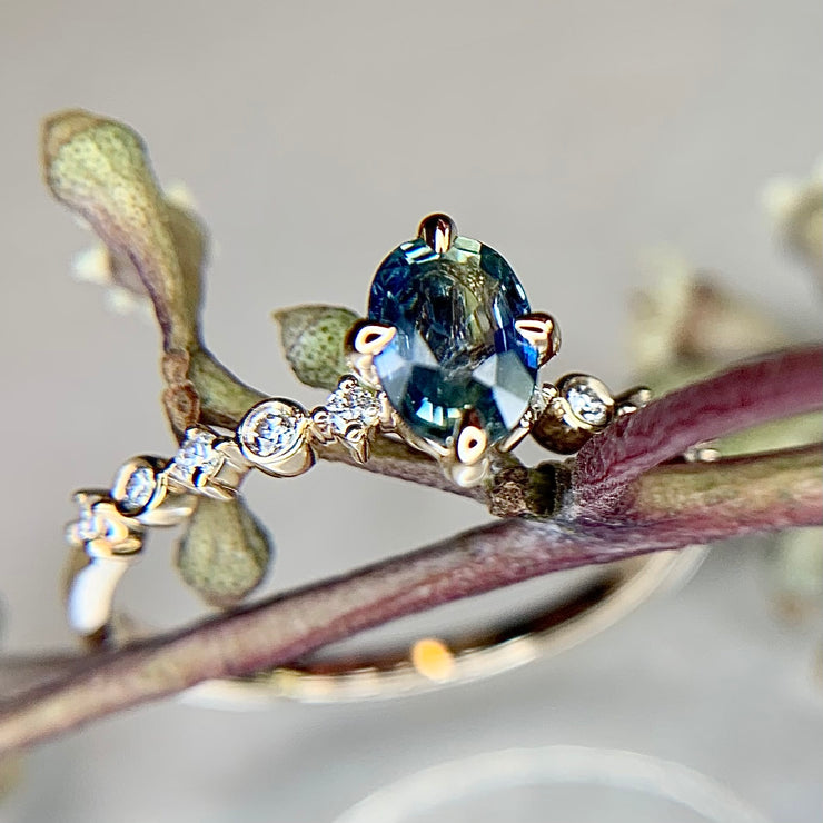 Blue green bicolor sapphire engagement ring with teal hues in yellow gold & diamond band by Dana Walden Bridal NYC