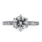 Six prong diamond solitaire engagement ring with a detailed art deco band. Dana Walden Bridal NYC.