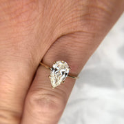 1.5 carat pear-shaped lab created diamond engagement ring set in yellow gold. DANA WALDEN BRIDAL.