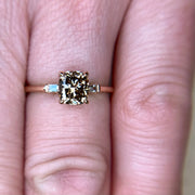 1 cara champagne diamond engagement ring with baguette side stones in rose gold on the hand by Dana Walden Bridal NYC