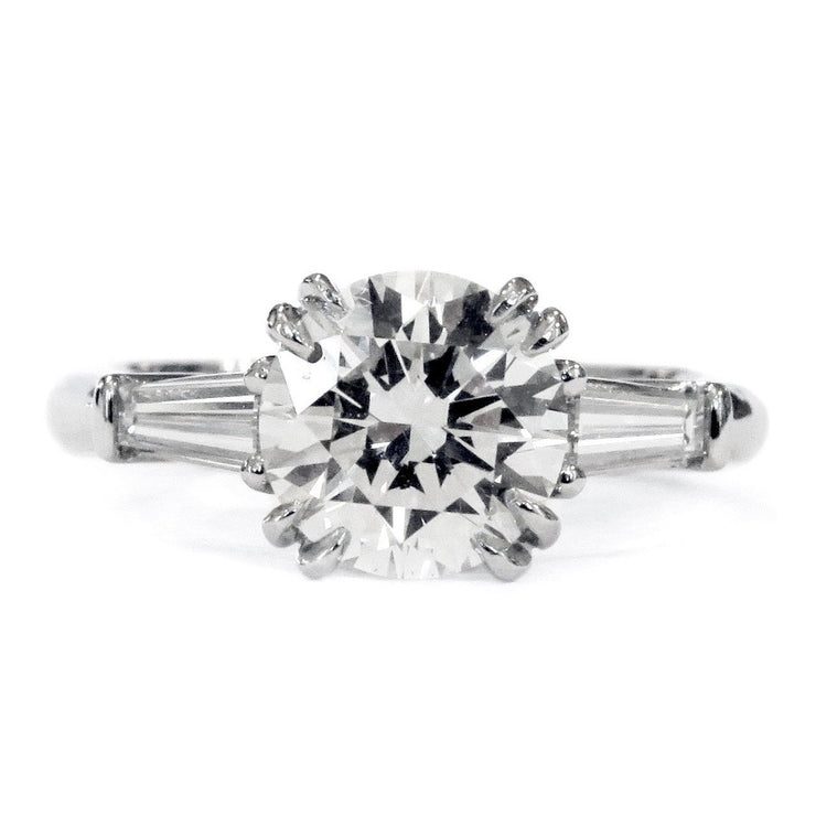 Conflict-free round diamond engagement ring with baguette diamond accents. Made in New York City.