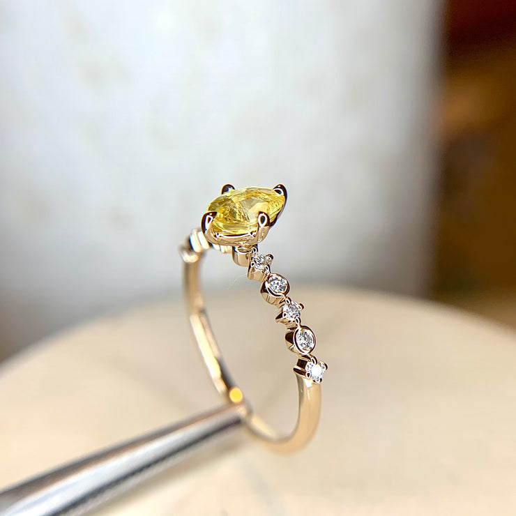 Yellow sapphire engagement ring with delicate diamond band in yellow gold by Dana Walden Bridal NYC