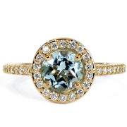 Aquamarine and diamond halo engagement ring set in yellow gold. DANA WALDEN JEWELRY NEW YORK CITY.