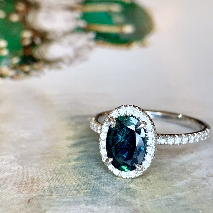 Teal sapphire with diamond halo and diamond micro pave set in white gold. DANA WALDEN BRIDAL. 