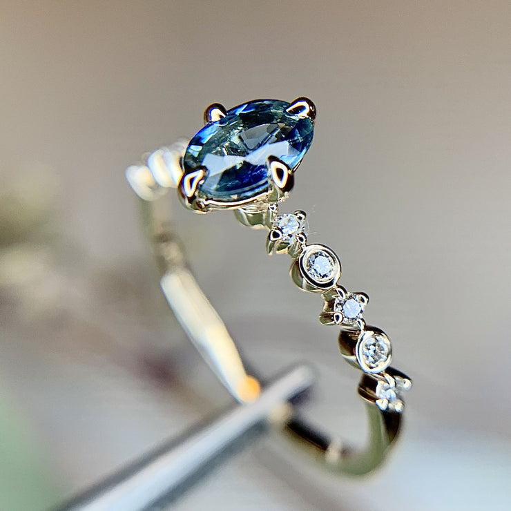 Anais oval light blue sapphire engagement ring in NSEW setting and unique delicate diamond band in 14k yellow gold by Dana Walden Bridal in NYC