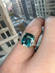 Natural Teal 5.11 Carat Sapphire 3 Stone Engagement Ring In Platinum with Triangle Natural Diamond Accents - Shown On Hand