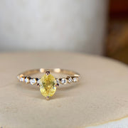 Oval yellow sapphire engagement ring in yellow gold with diamond accents & NSEW compass prongs by Dana Walden Bridal NYC