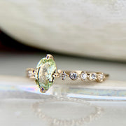 Oval light green sapphire engagement ring in yellow gold by Dana Walden Bridal, NYC
