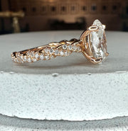 Side profile of lab grown diamond engagement ring with twisted diamond paved band and 1.47 carat lab grown oval diamond center stone in 18k rose gold