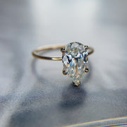 1.5 carat pear-shaped lab created diamond engagement ring set in yellow gold. DANA WALDEN BRIDAL.