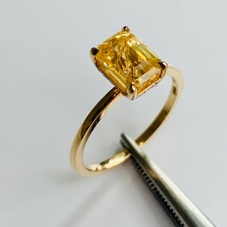 Alternative Yellow sapphire engagement ring in emerald cut on delicate gold band