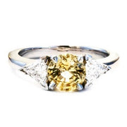 Unique engagement ring with yellow sapphire center and triangle diamond accents. By Dana Walden Bridal in New York City.
