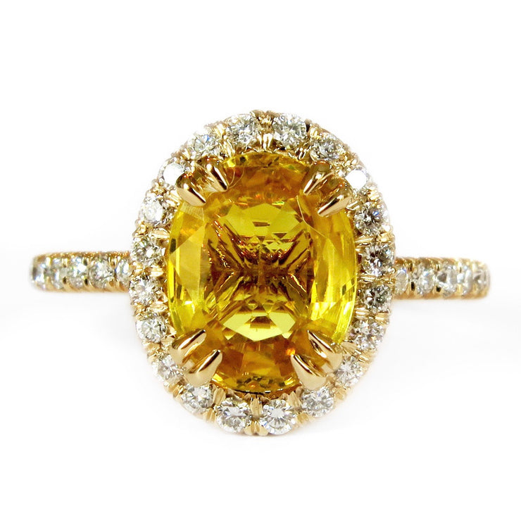 Oval yellow sapphire with diamond halo set in yellow gold. The Gia ring by Dana Walden Bridal in New York City.