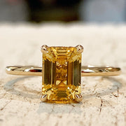 Unique emerald cut yellow sapphire in gold with delicate gold custom setting 