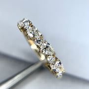 Diamond wedding band with alternating pear-shaped white diamonds and round diamonds. DANA WALDEN BRIDAL NYC.
