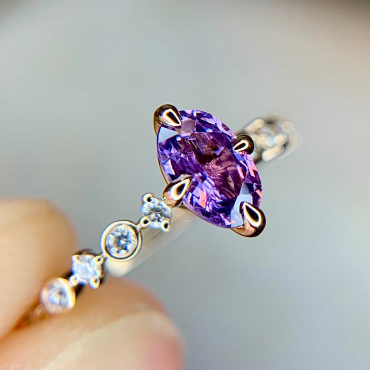 Oval purple sapphire engagement ring with delicate diamond band in yellow gold and NSEW compass prongs by Dana Walden Bridal NYC