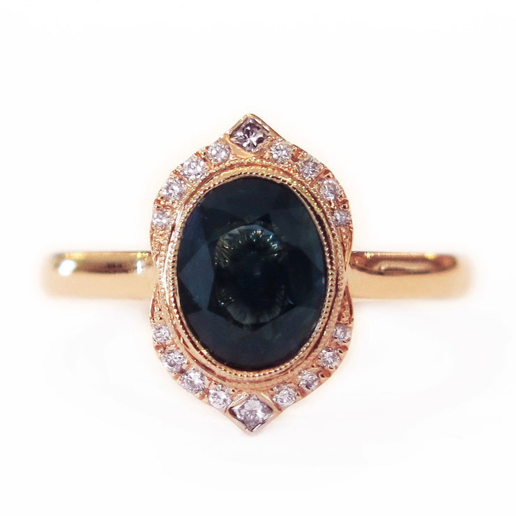 Tillary teal sapphire oval engagement ring set in rose gold with diamond accents. DANA WALDEN BRIDAL.