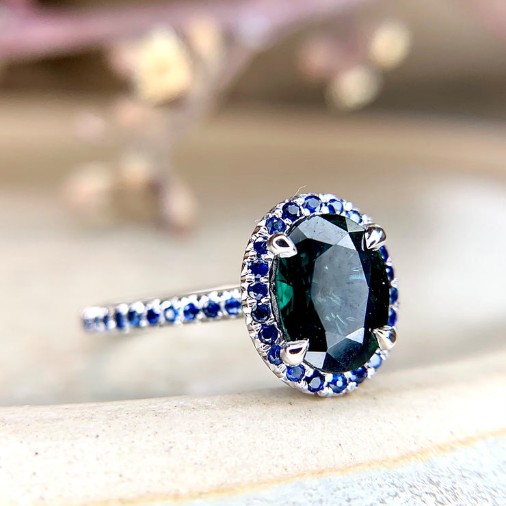 Gothic, handmade engagement ring with teal and blue sapphires set in white gold. Dana Walden Jewelry NYC.