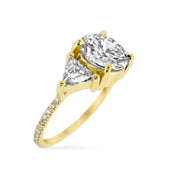 Three stone engagement ring with micro pave diamond accents on the band. DANA WALDEN BRIDAL.