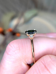 Unique, handmade teal sapphire engagement ring, made with conflict-free gemstones by Dana Walden Bridal in New York City.