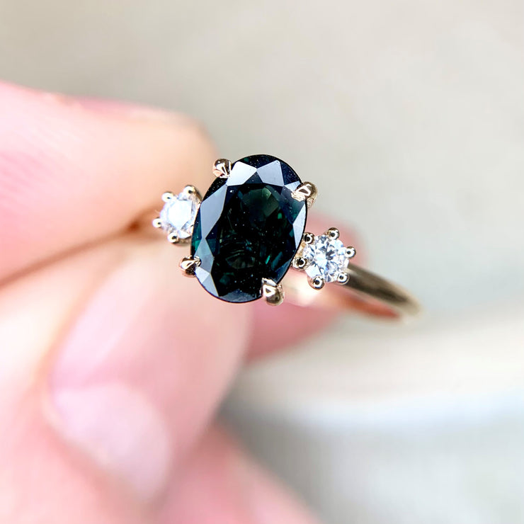 Unique, handmade teal sapphire engagement ring, made with conflict-free gemstones by Dana Walden Bridal in New York City.