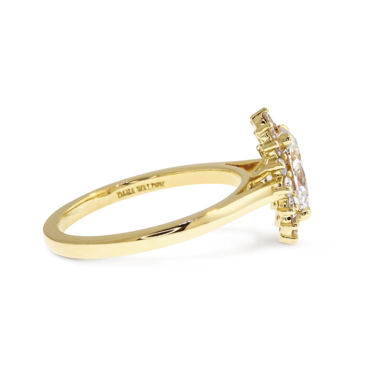 SIDE VIEW: Oval diamond halo engagement ring with tipped prongs in yellow gold. DANA WALDEN NYC.